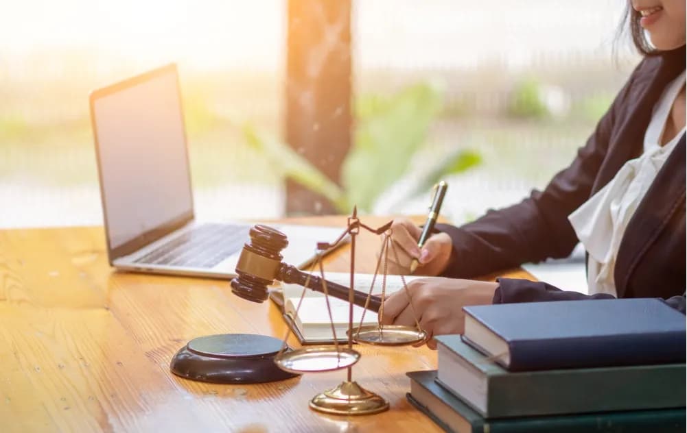 Car accident victim consulting with an attorney while reviewing legal documents, insurance paperwork, and evidence related to an accident claim.