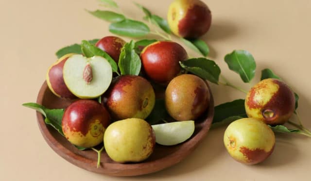Fresh ripe Jujube fruits on wooden plate